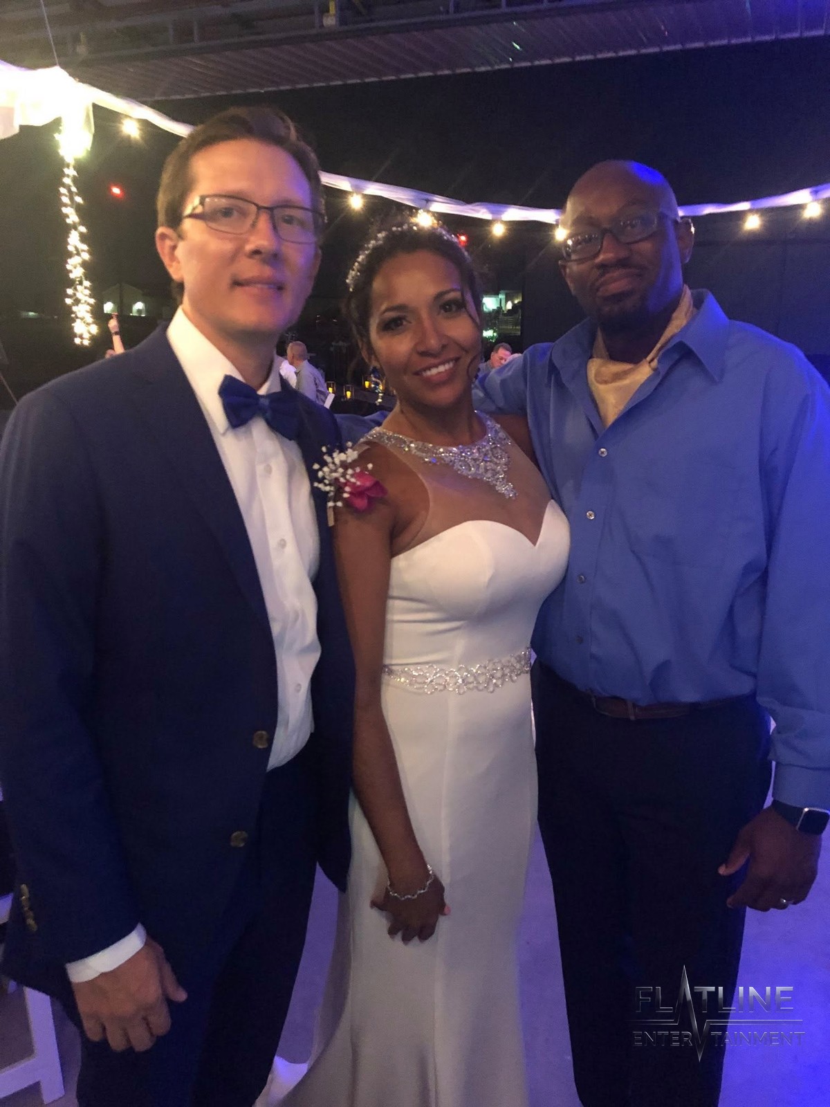 Lisa and Adam with a guest at their wedding, smiling