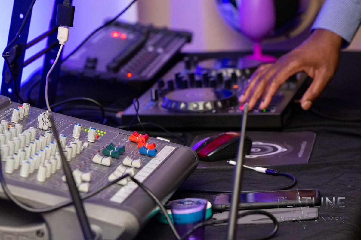 The DJ mixer, turntables, and laptop set up and ready to play