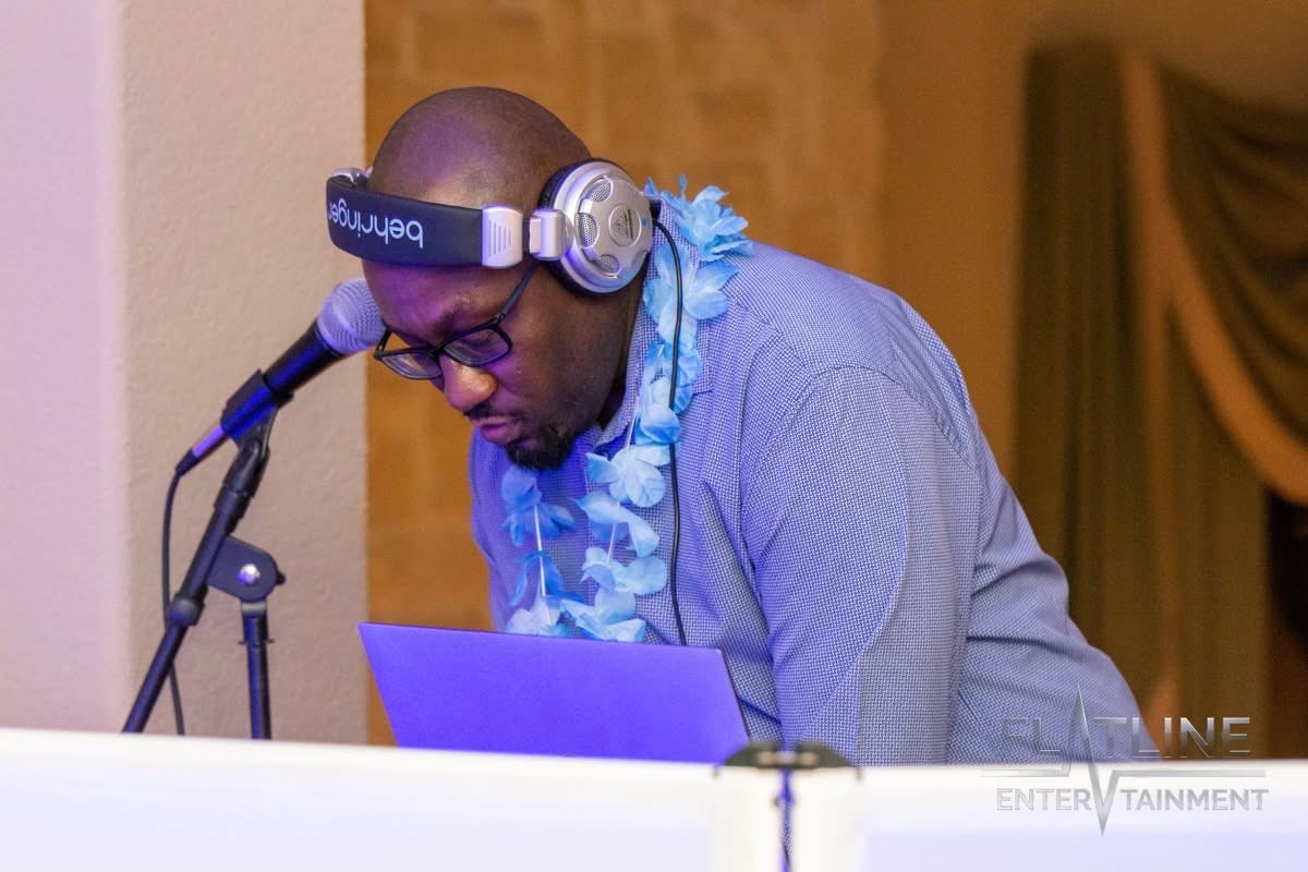 Mark Anthony close up at the DJ booth, headphones on