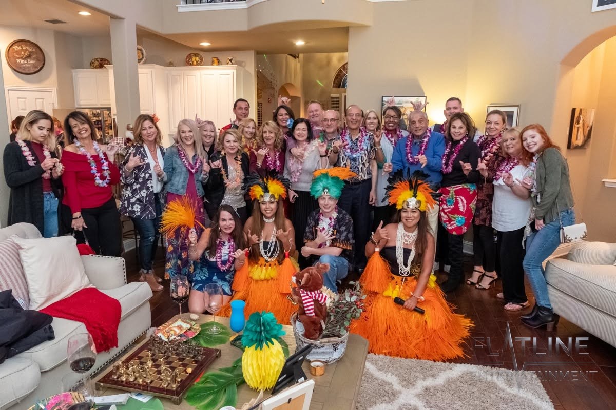 Hula dancers performing for a crowd at a birthday party