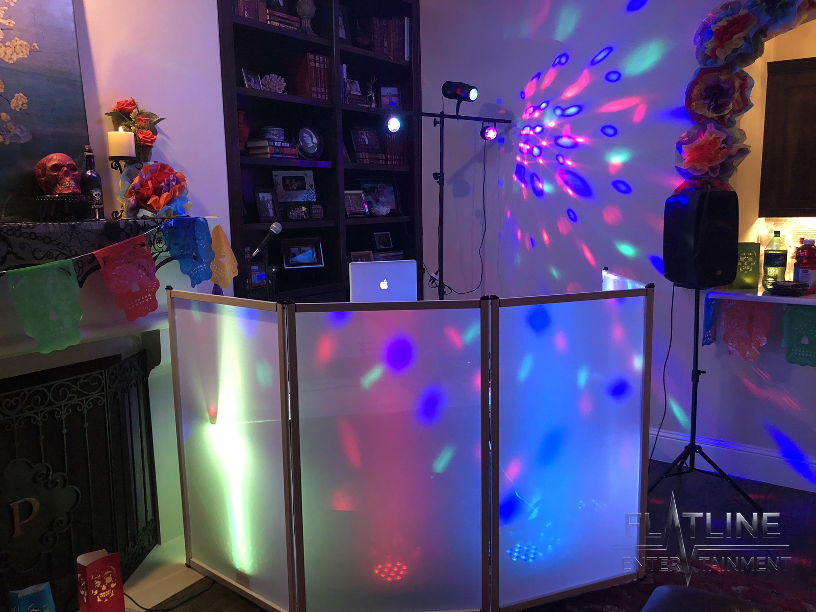 The Flatline DJ booth with glowing panels and disco lights washing the wall